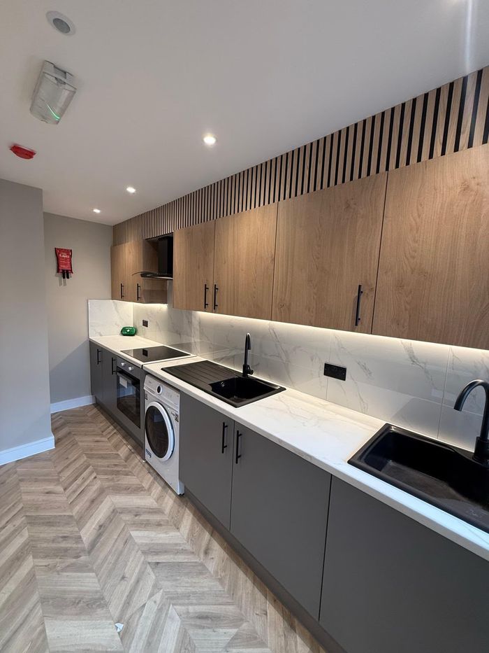 Finished kitchenette with boxed-in services and emergency lighting